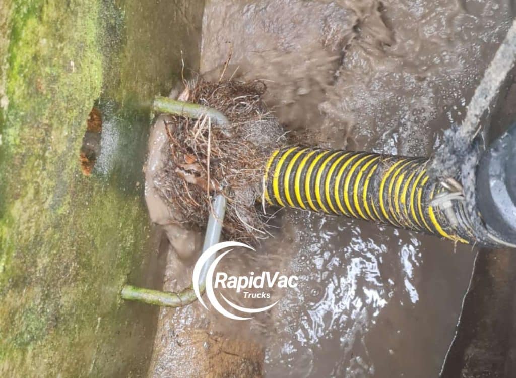 Using specialised vacuum truck equipment to clear blocked drains from tree roots in Perth.